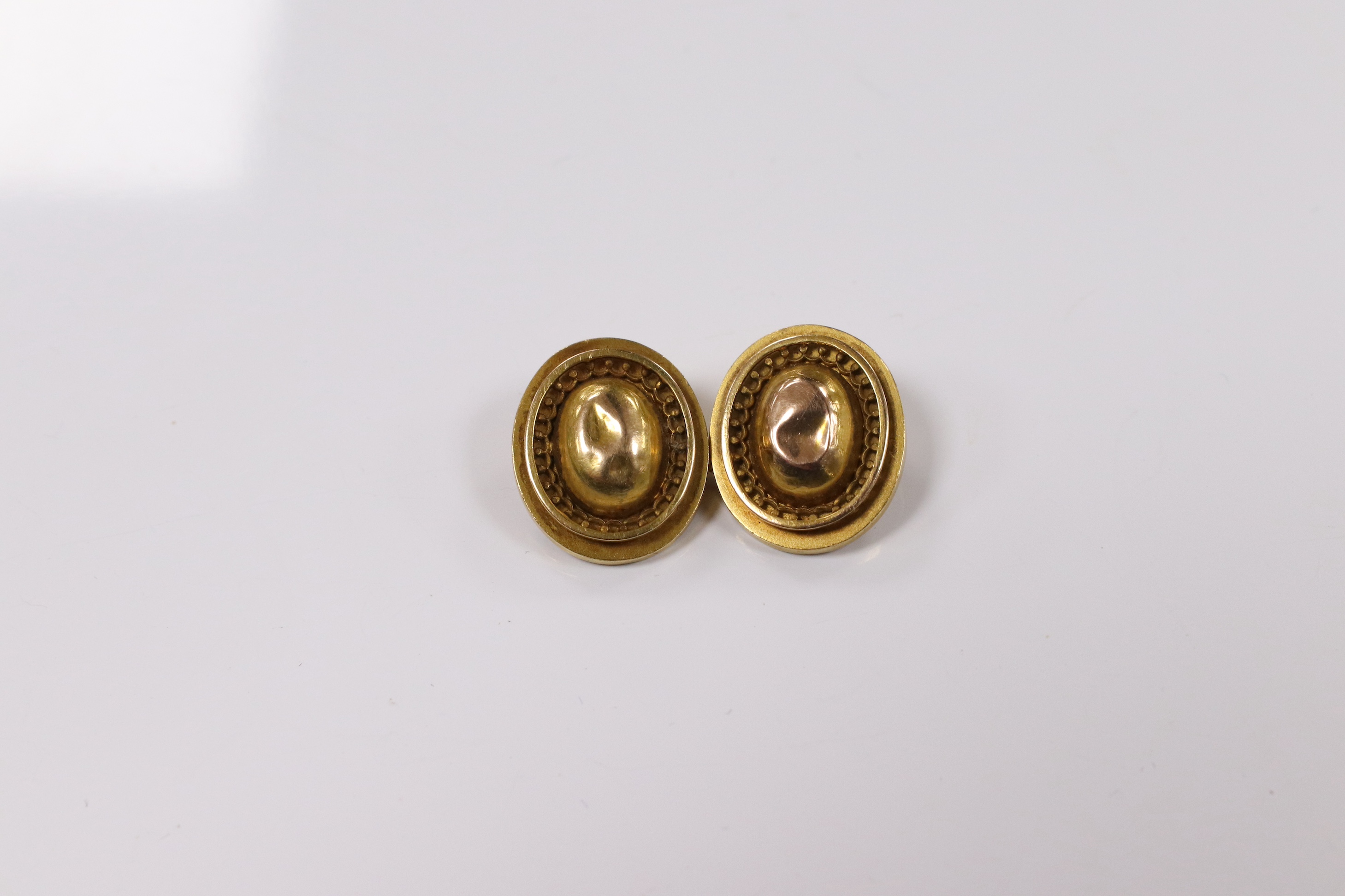 A pair of yellow metal oval cufflinks and three similar dress studs, one stamped 18, gross weight 10.8 grams. Condition - poor